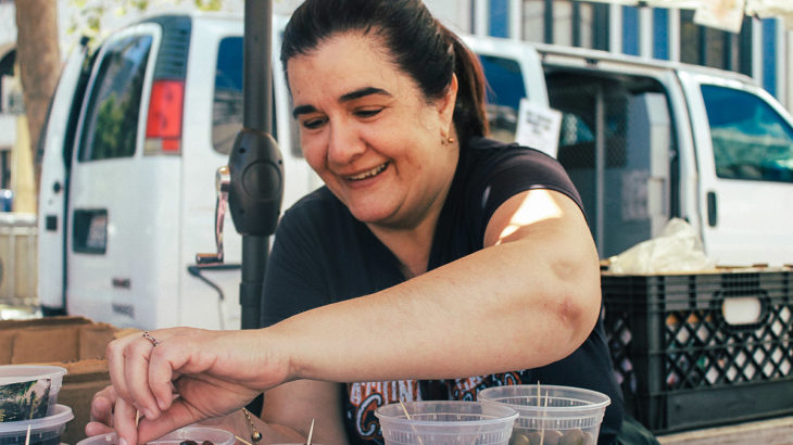 Maria Moustakis, Olive Vendor at the Heart of the City Farmers’ Market. Photo by Rua Al-Abweh.