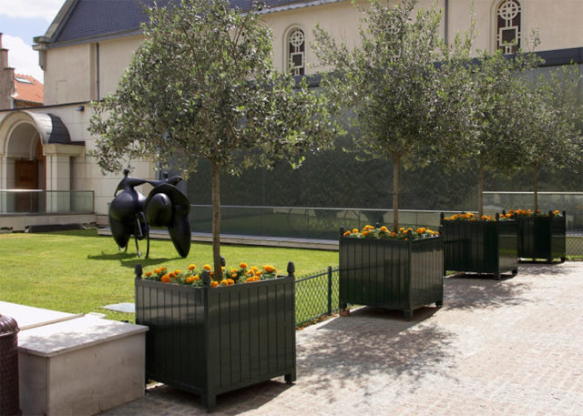 Moveable planters can accommodate small trees or plantings, and can be placed on lockable casters